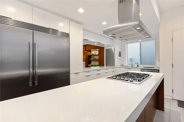 a kitchen with stainless steel appliances granite countertop a refrigerator a sink and a stove