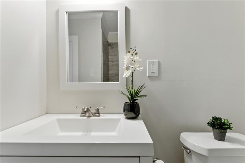 1411 Mercer Avenue Atlanta, GA 30337 - Photo 15 of 21 a bathroom with a sink a toilet and a mirror