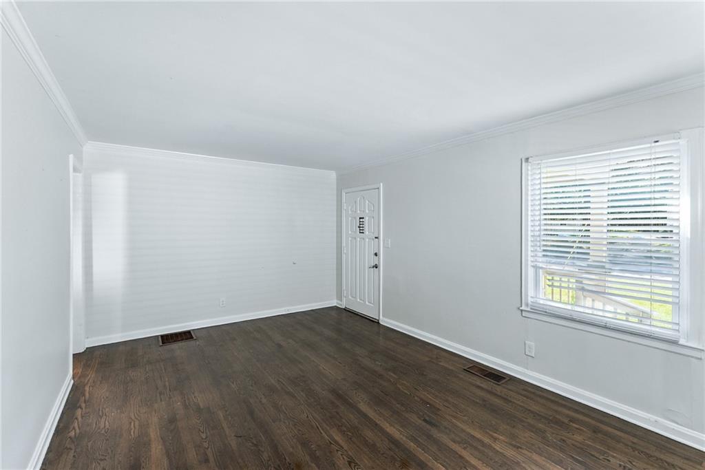 1411 Mercer Avenue Atlanta, GA 30337 - Photo 19 of 21 an empty room with wooden floor and windows