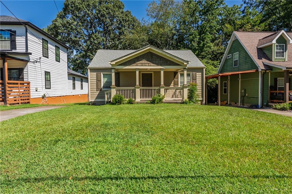 1411 Mercer Avenue Atlanta, GA 30337 - Photo 20 of 21 a front view of a house with a yard and trees