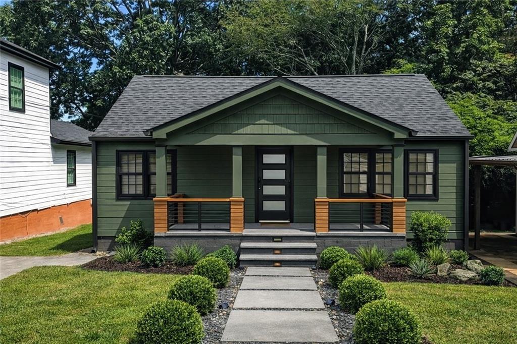 1411 Mercer Avenue Atlanta, GA 30337 - Photo 2 of 21 a front view of a house with a yard