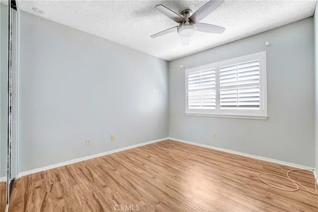 a view of a big room with wooden floor and windows in a room