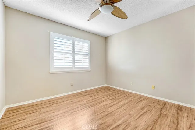 a view of a room with wooden floor and windows