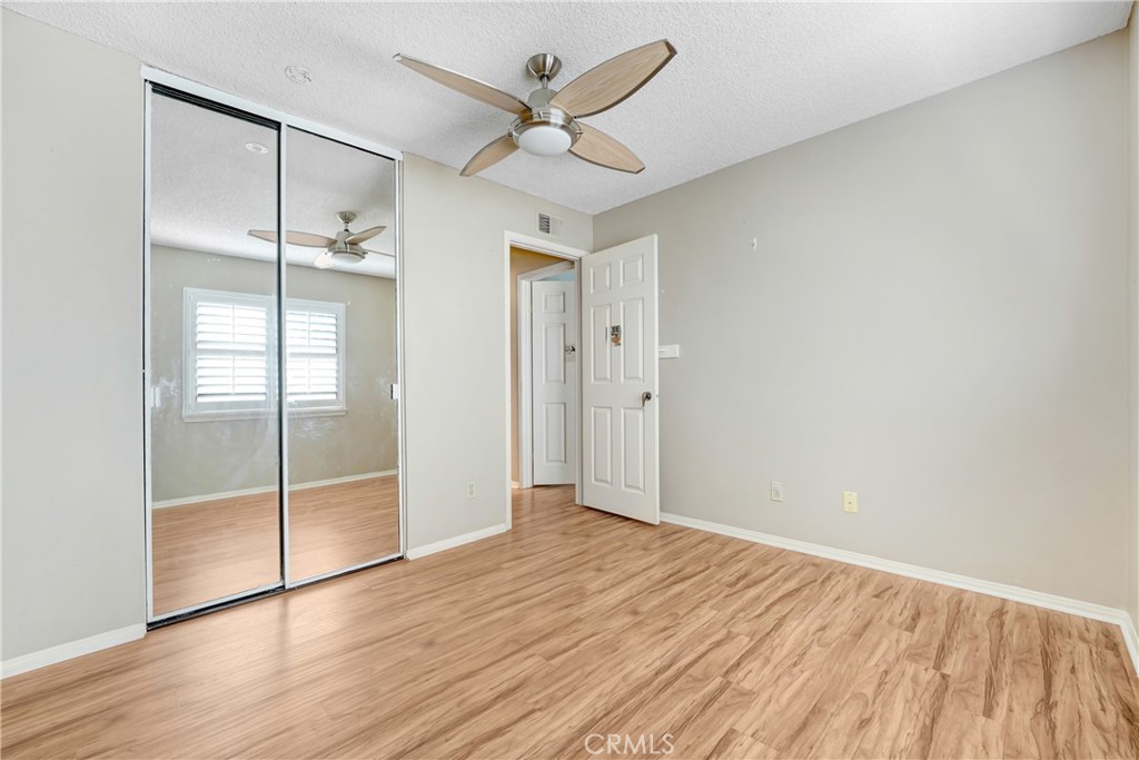 5514 Las Virgenes Road Calabasas, CA 91302 - Photo 17 of 20 an empty room with wooden floor and a ceiling fan