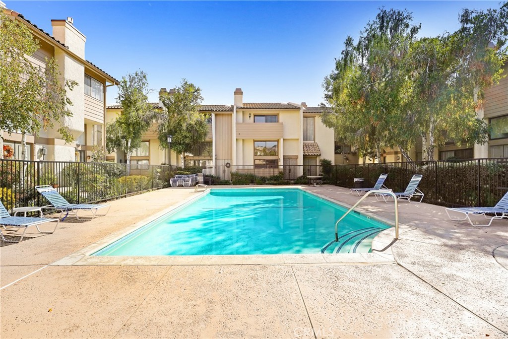 5514 Las Virgenes Road Calabasas, CA 91302 - Photo 20 of 20 a view of a patio with a table and chairs under an umbrella