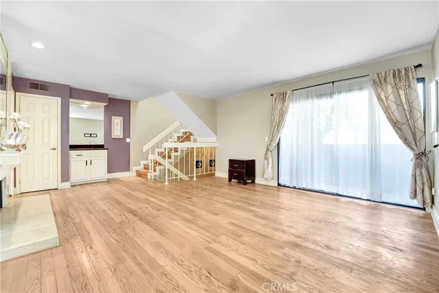 a room with a bed and a view of kitchen
