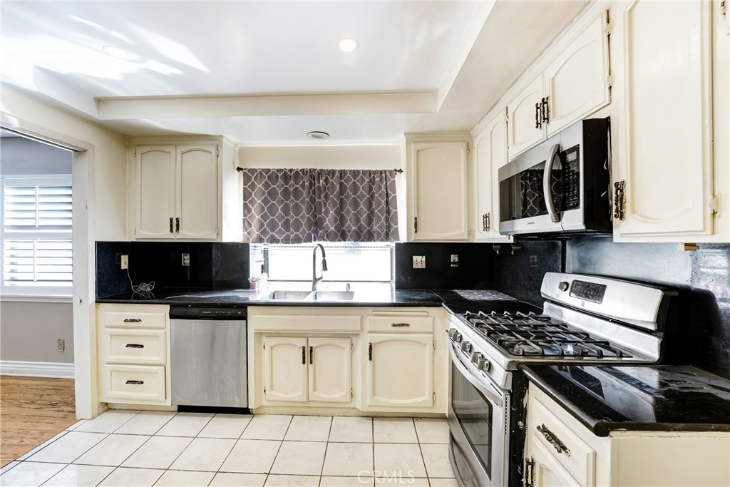 5514 Las Virgenes Road Calabasas, CA 91302 - Photo 6 of 20 a kitchen with stainless steel appliances a stove a sink and a microwave