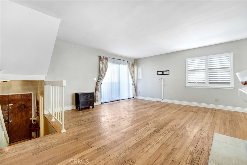 5514 Las Virgenes Road Calabasas, CA 91302 - Photo 8 of 20 an empty room with wooden floor and windows