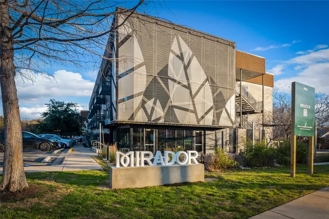 a view of house with a yard and sitting area