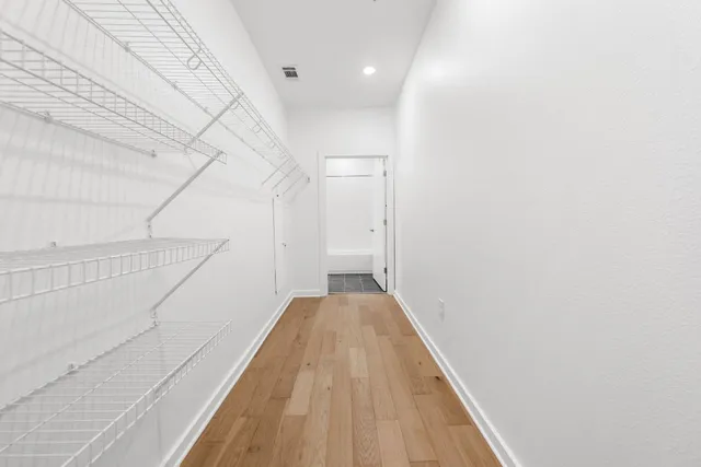a view of a hallway with stairs