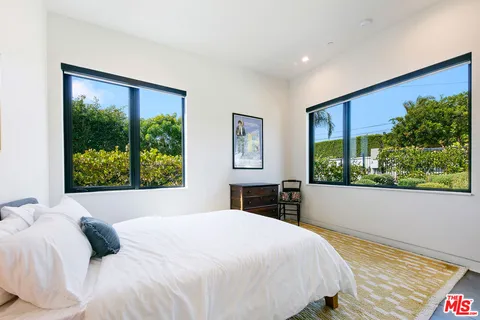a bedroom with a large bed and a large window