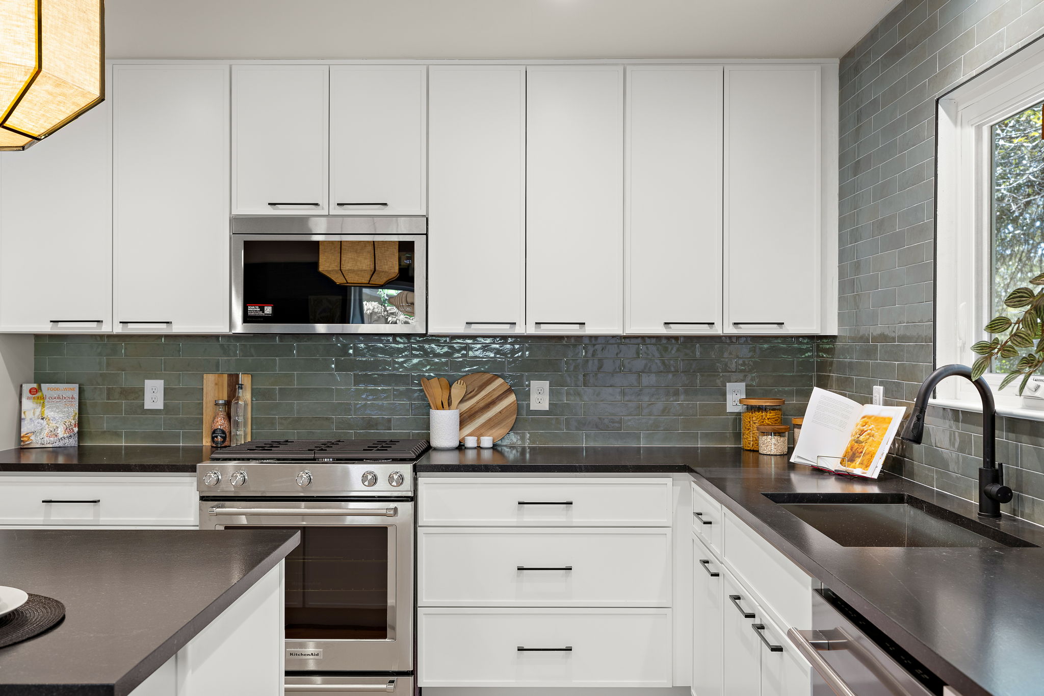 8102 Burrell Drive Austin, TX 78757 - Photo 11 of 31 a kitchen with granite countertop a stove a sink and dishwasher with white cabinets