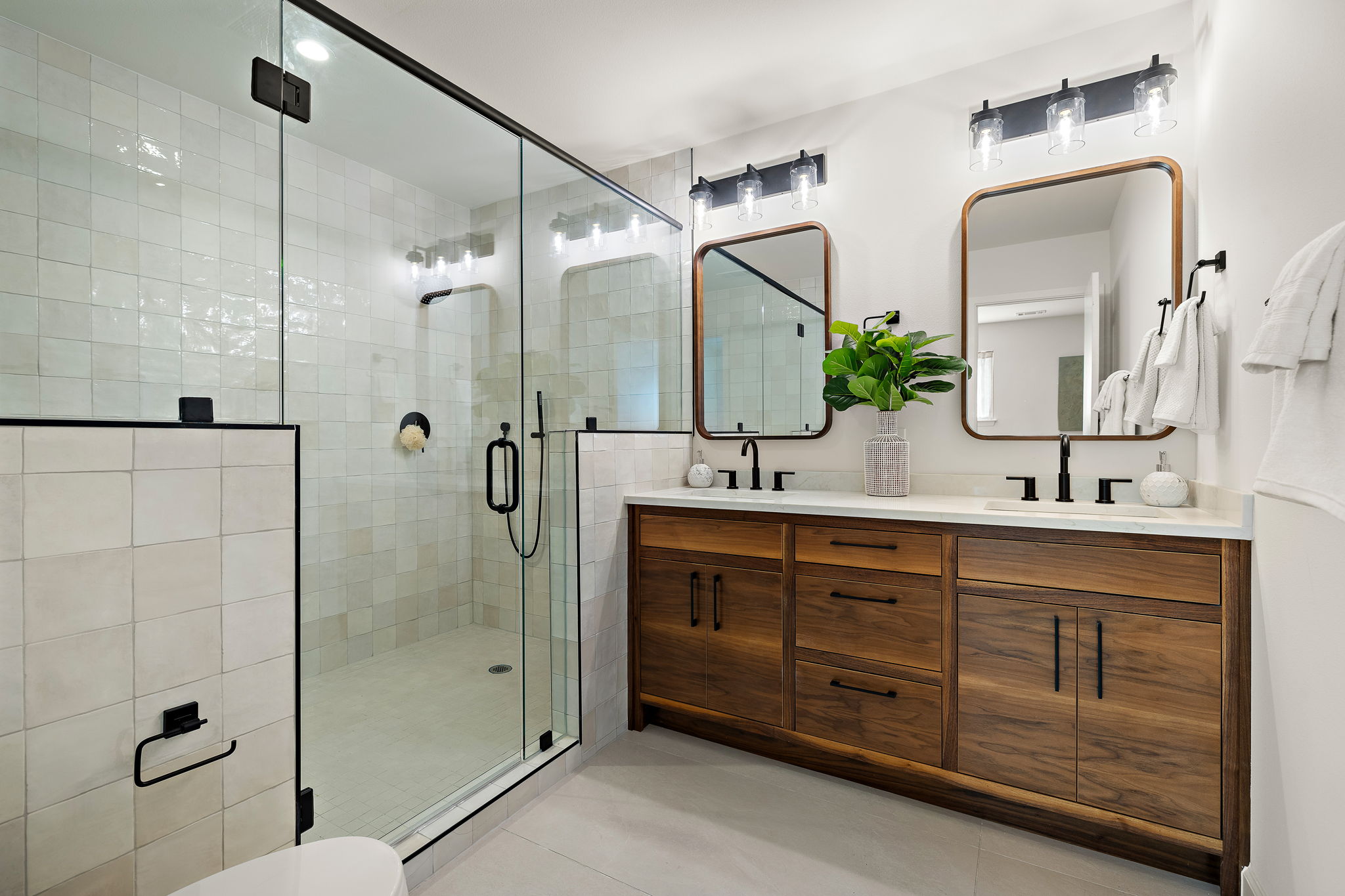 8102 Burrell Drive Austin, TX 78757 - Photo 17 of 31 a bathroom with a double vanity sink mirror and shower