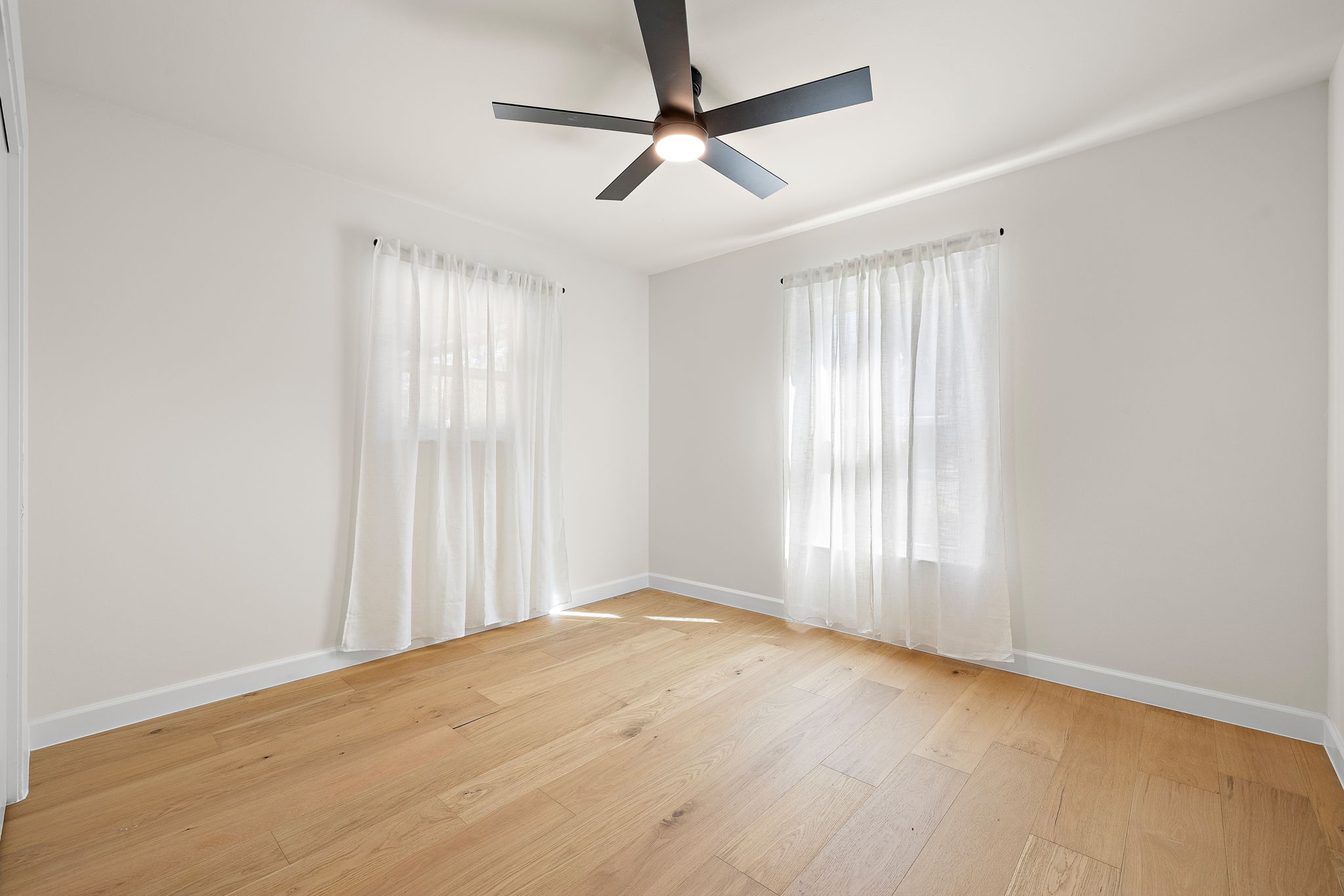 8102 Burrell Drive Austin, TX 78757 - Photo 21 of 31 wooden floor in an empty room with a window