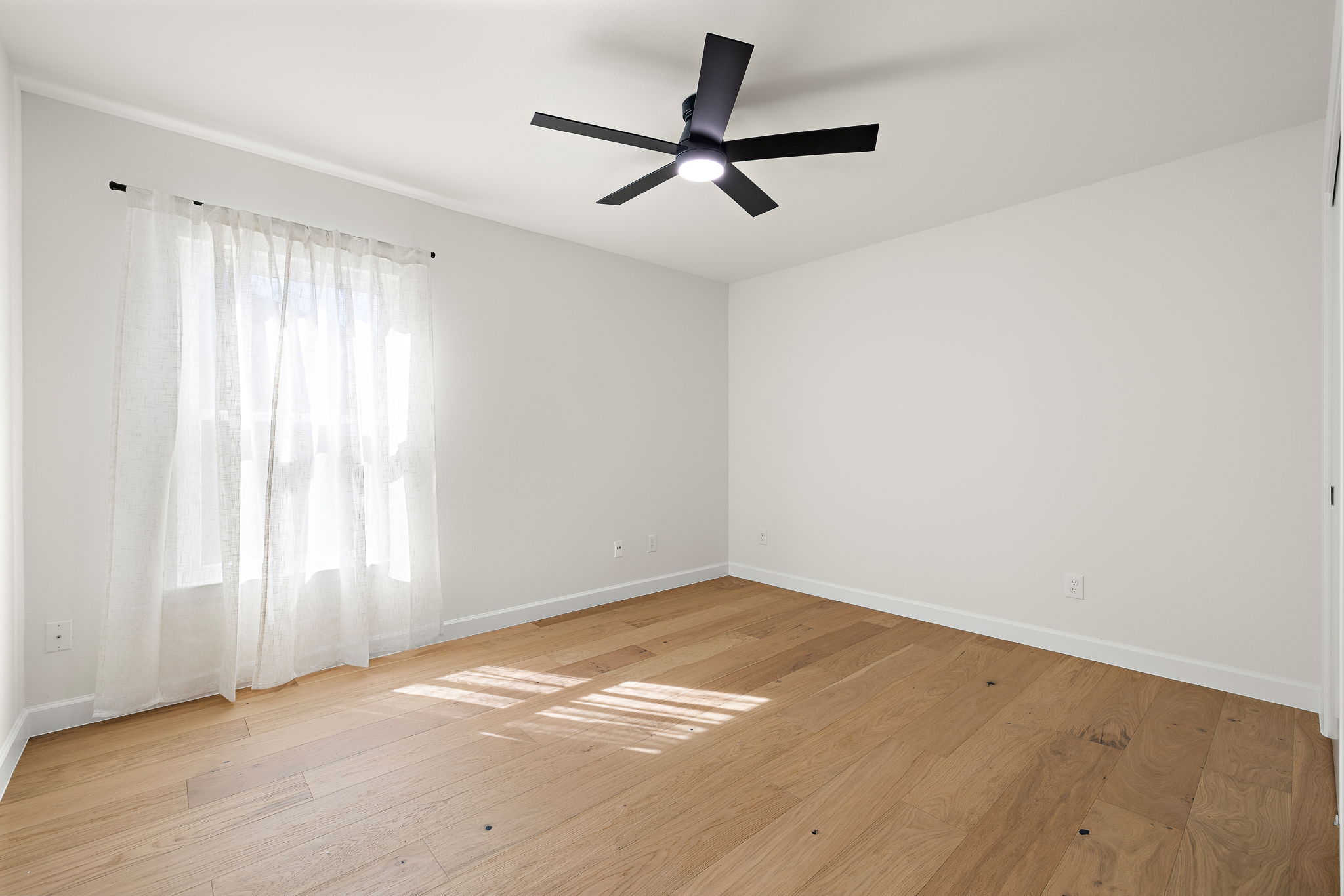 8102 Burrell Drive Austin, TX 78757 - Photo 22 of 31 a view of a big room with wooden floor closet and windows