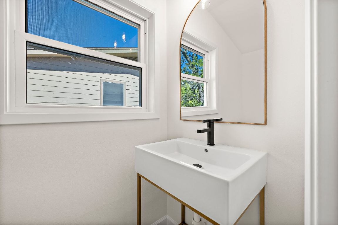 8102 Burrell Drive Austin, TX 78757 - Photo 26 of 31 a bathroom with a sink and a mirror