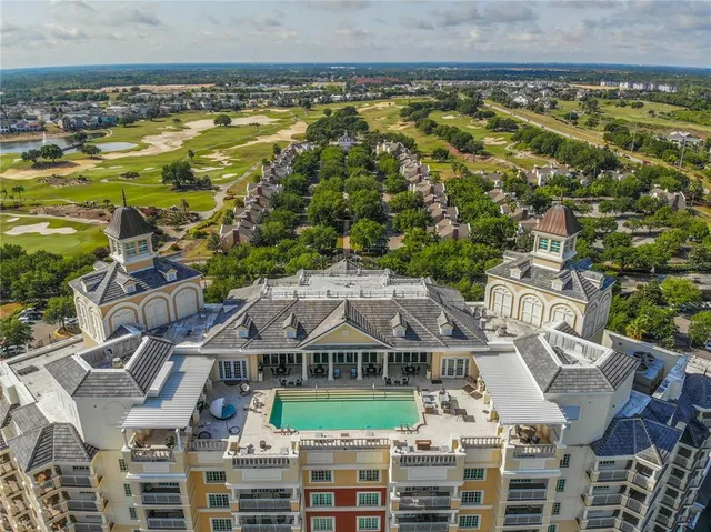 an aerial view of residential houses with outdoor space and parking