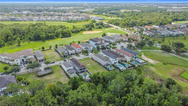 an aerial view of residential houses with outdoor space and river