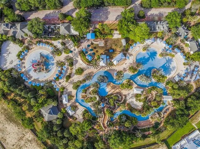 an aerial view of residential house with outdoor space and trees all around