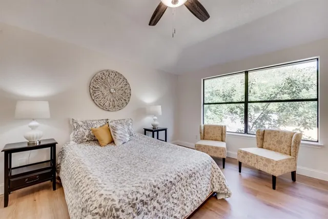 a bedroom with furniture and a large window