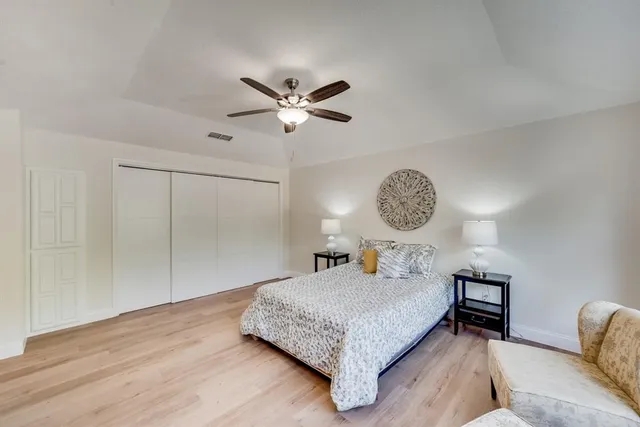 a bedroom with a bed mirror and a window