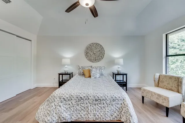 a bedroom with a large bed and a couch