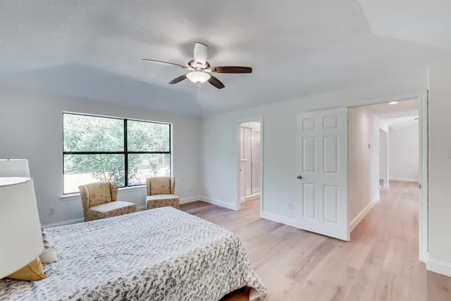 a bedroom with a large bed and a window