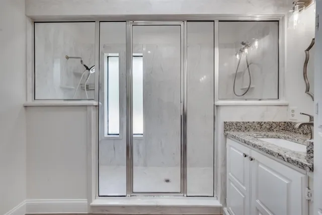a bathroom with a shower and a sink
