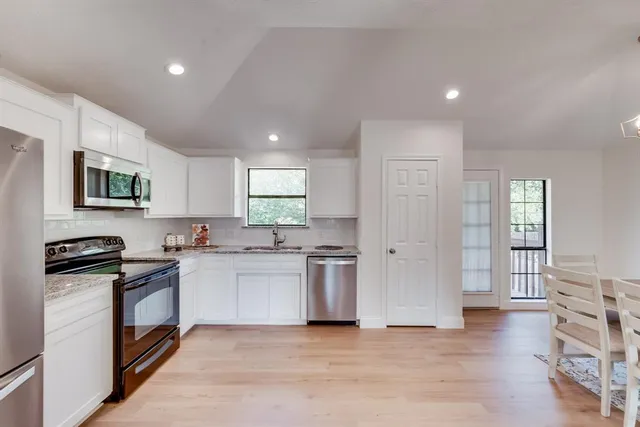 a kitchen with a stove a sink and a refrigerator