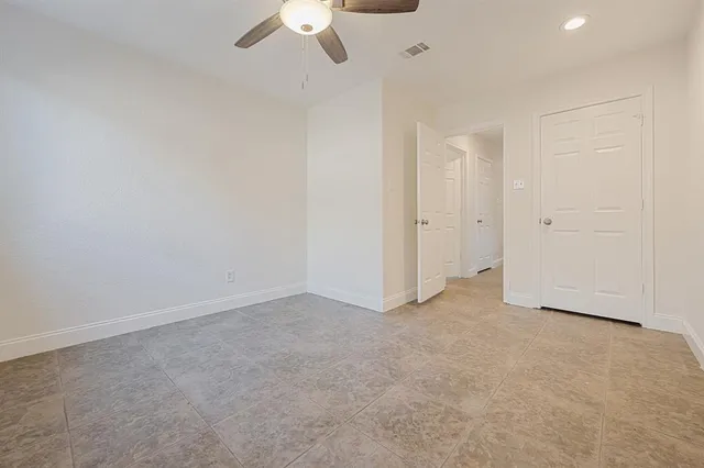 an empty room with a empty space and a ceiling fan
