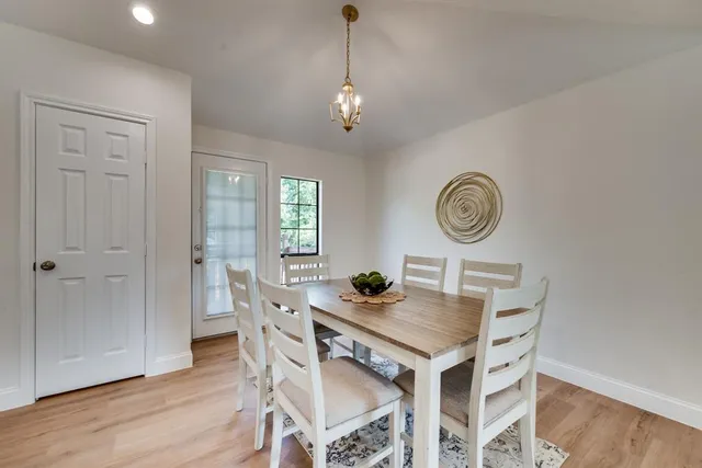 a dining room with furniture a window and wooden floor
