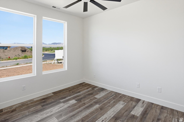 1315 West 3200 South, Unit 17 Perry, UT 84302 - Photo 20 of 58 Interior space featuring two windows, wood-finish flooring, white walls, white baseboards, and a black ceiling fan