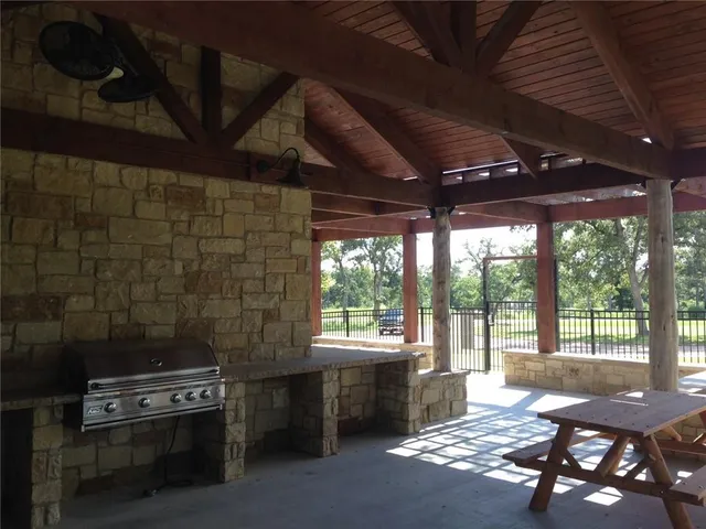 a view of a porch with furniture and a yard