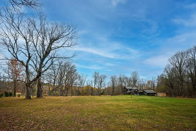 a view of a field with trees around