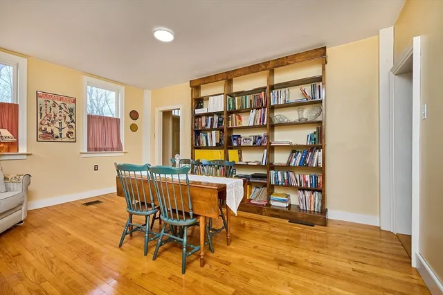 a view of a workspace room with furniture and wooden floor