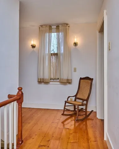 a view of a livingroom with chair and a window
