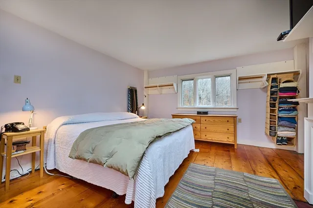 a bed room with a bed and a large window