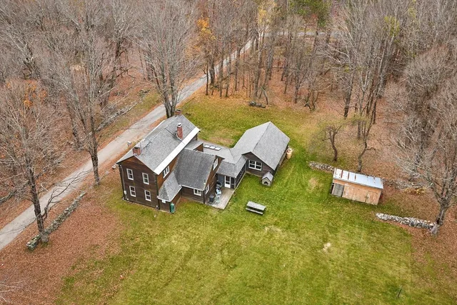 a backyard of a house with outdoor seating and trees