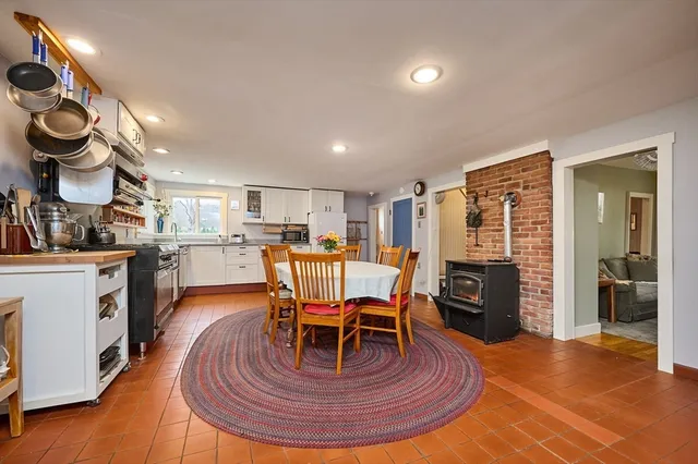 a living room with furniture a dining table and kitchen view