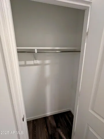 a view of a hallway with wooden floor and entryway