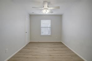 1304 Robin Street Houston, TX 77019 - Photo 9 of 11 Bedroom 3 with a large walk in closet, newnvinyl flooring, blinds & ceiling fan.