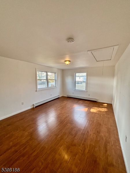 145 Brighton Avenue Belleville, NJ 07109 - Photo 13 of 15 an empty room with wooden floor and windows