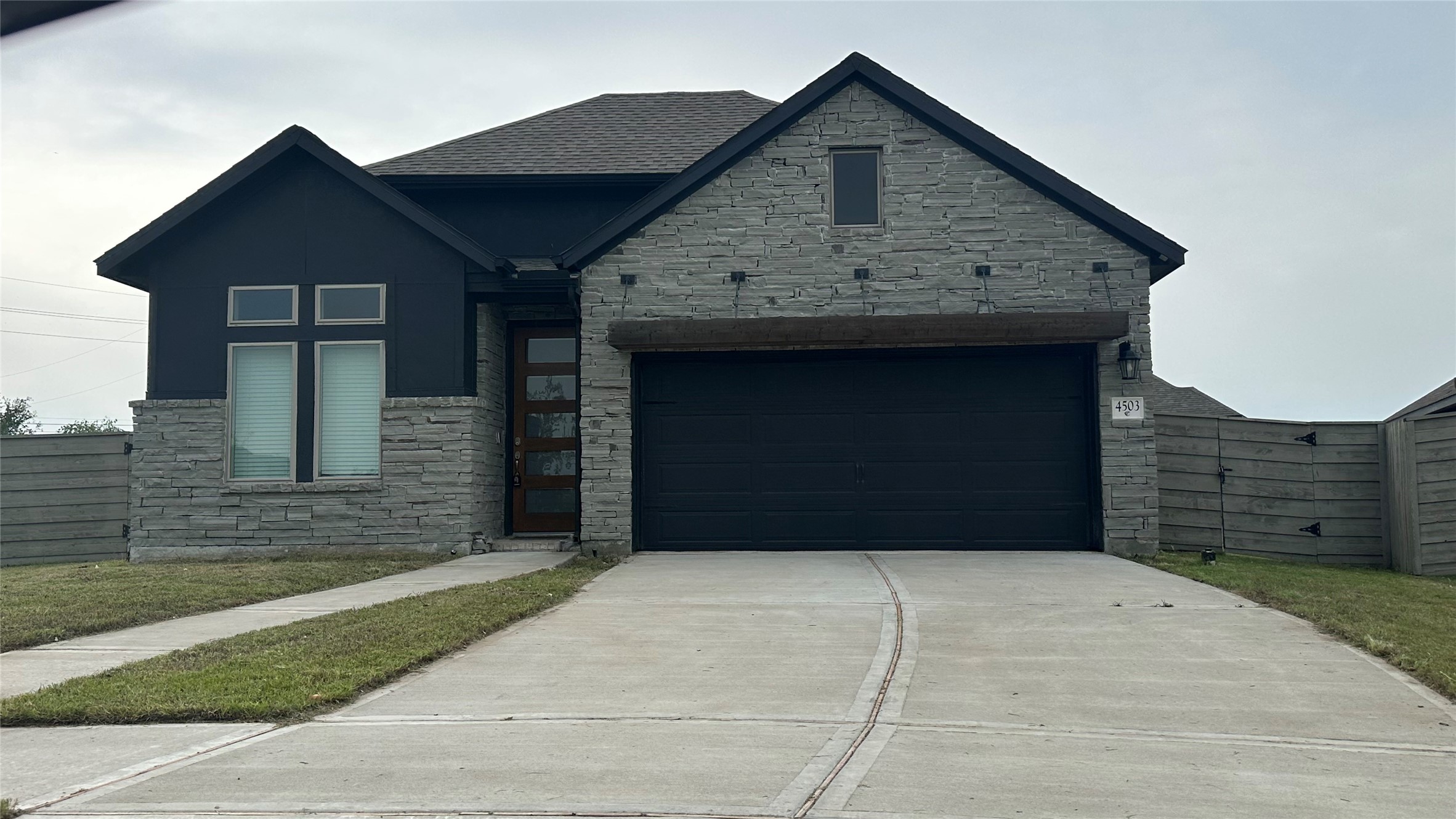4503 Cedar Butte Lane Manvel, TX 77578 - Photo 1 of 16 Custom Stone Front with sleek modern door.