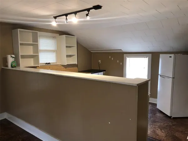 a kitchen with a refrigerator and window