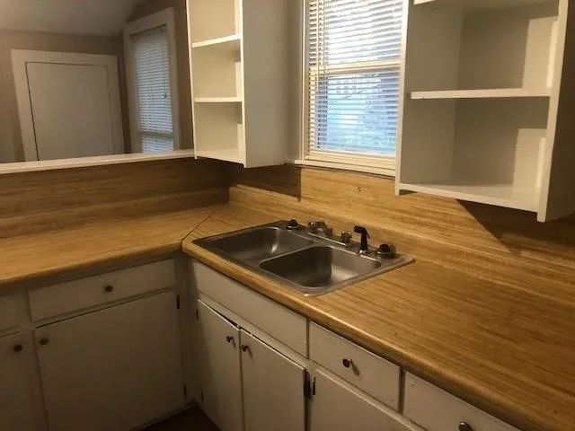 a kitchen with a sink and cabinets