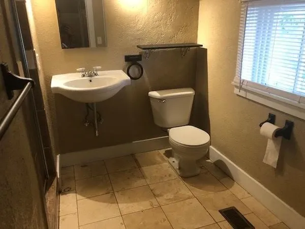 a bathroom with a toilet and a sink
