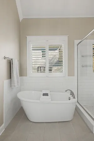 a bathroom with a bathtub and a shower