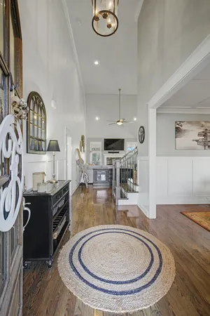 a view of a livingroom with wooden floor and furniture