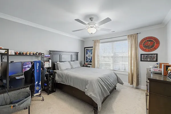 a bedroom with a large bed and a large window