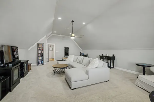a balcony with wooden floor table and chairs